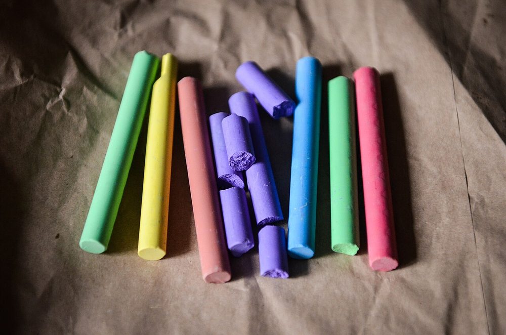 Sticks of coloured chalk on paper